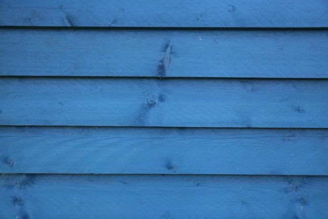closeup of painted blue wooden siding