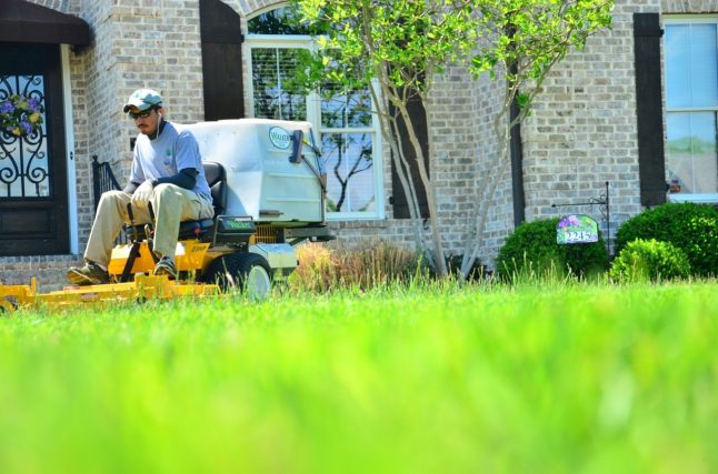 man on riding lawn mower