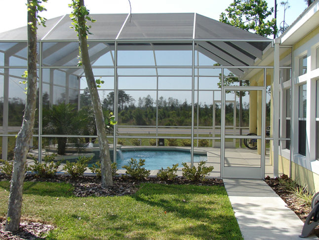 Swimming pool with glass enclosure