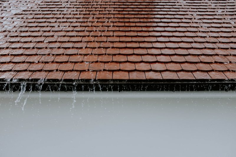 water running down tiled roof