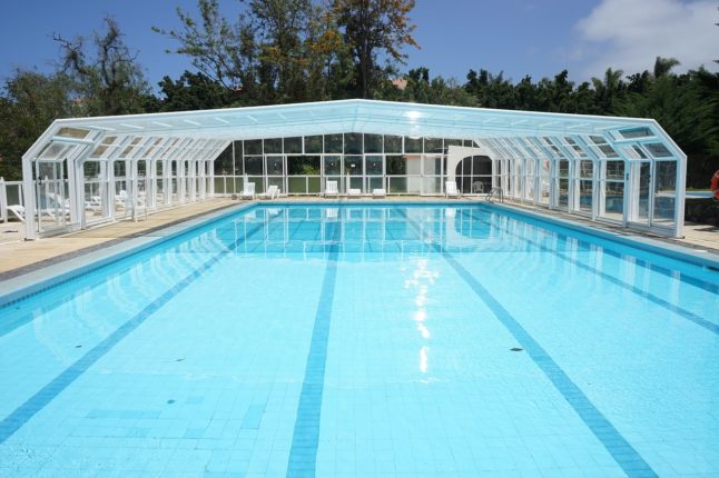 swimming pool with glass enclosure
