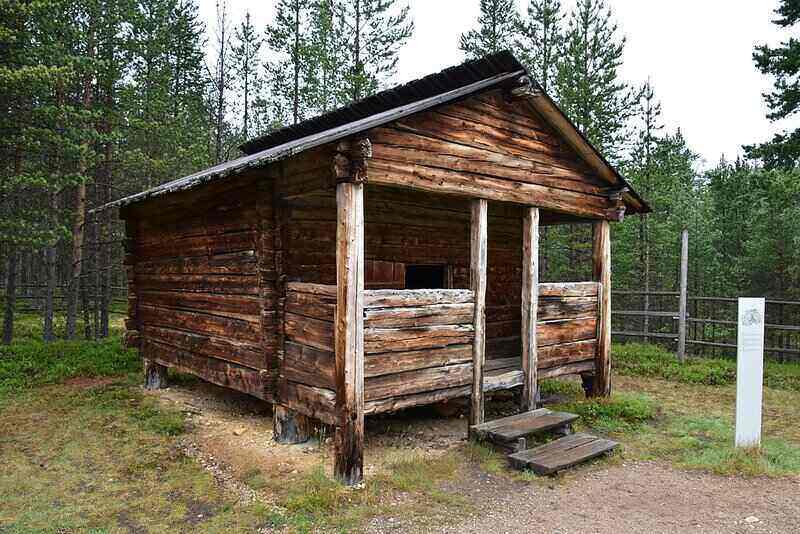 Old wooden shed with steps and an open porch area