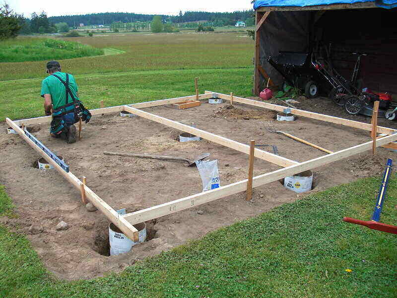 Man installing wood framing over a prepared site