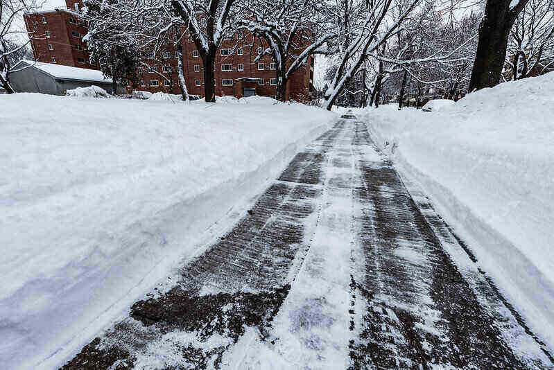 snow freshly removed from a sidewalk