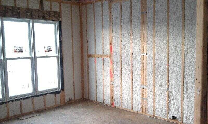 Room with exposed framing and newly installed insulation