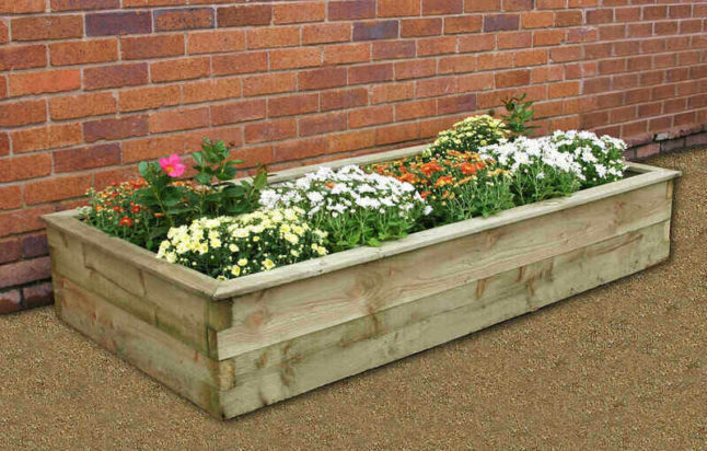 Raised garden bed with various flowers planted
