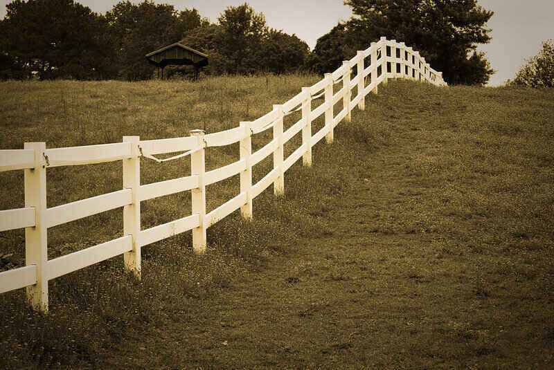 White wooden fence following the lay of the land
