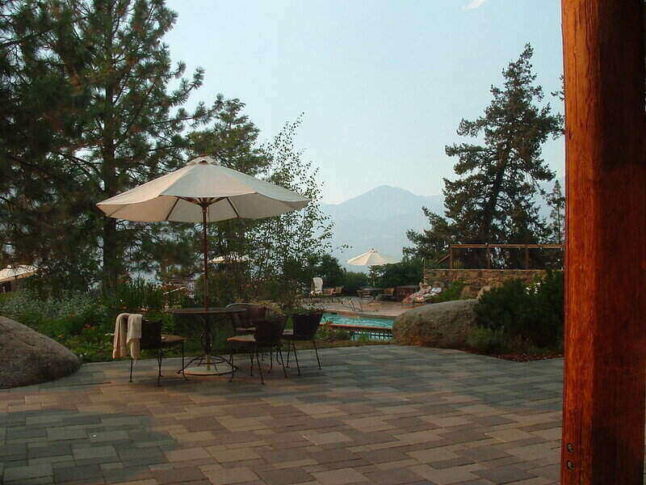 paver patio with pool and mountains in background