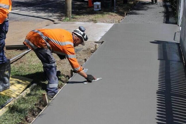 contractor smoothing concrete sidewalk