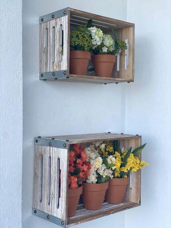wooden crates holding potted plants on wall