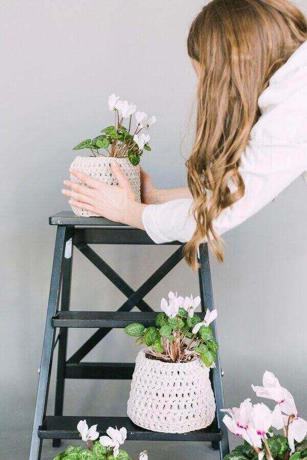 woman taking care of potted plants
