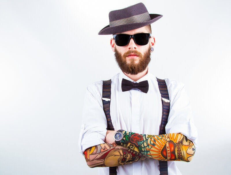 tattooed hipster man with fedora and sunglasses