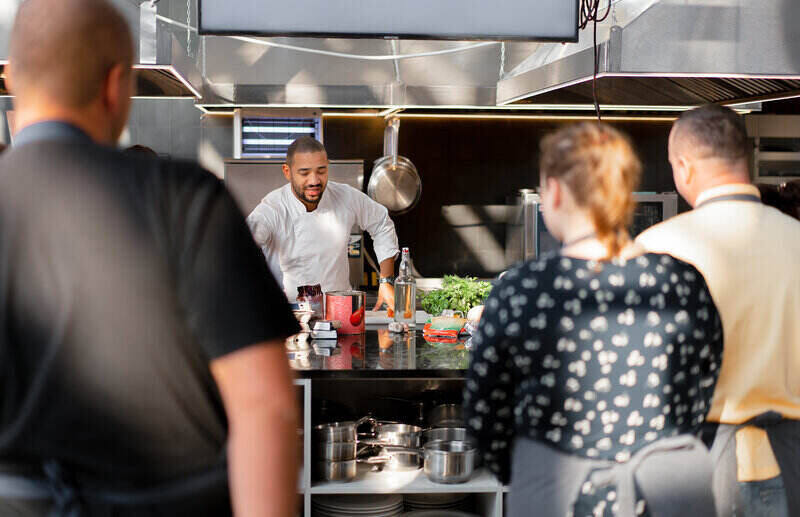 man teaching a cooking class to aspiring chefs