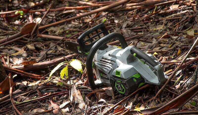 battery-powered chainsaw sitting on the ground
