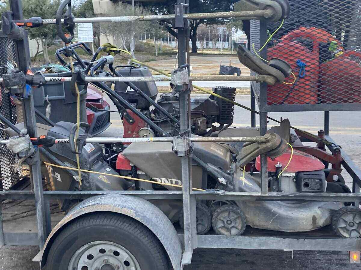 A lawn care crew's trailer with lawn mower and other lawn care equipment