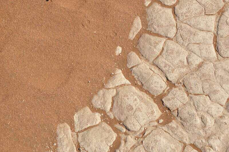 Sandy soil next to rock