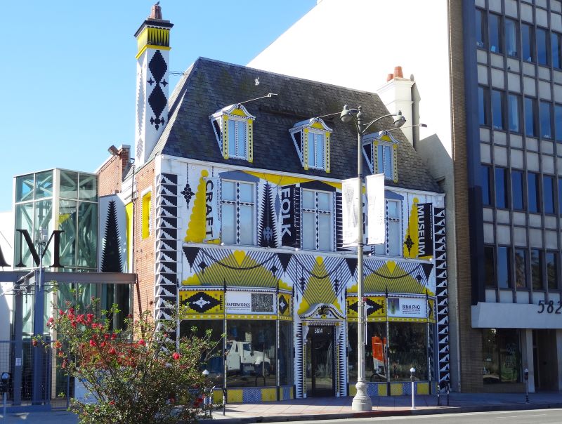 A shot of the yellow-and-black geometric-patterned façade of the Craft Contemporary museum (formerly the Craft & Folk Art Museum) in Los Angeles