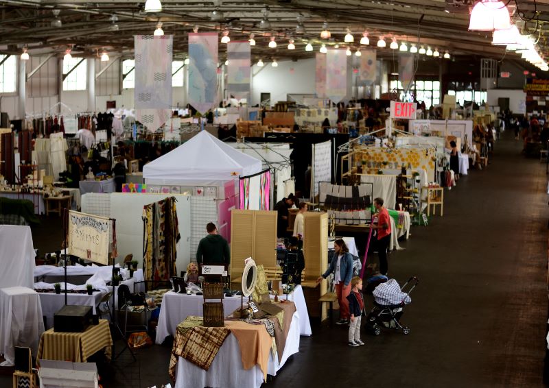 A handful of shoppers browse the stalls at the Renegade Craft Fair in Brooklyn, New York during a quiet hour.