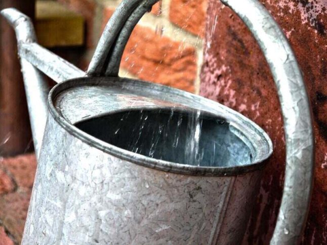 water dripping into a metalic watering can