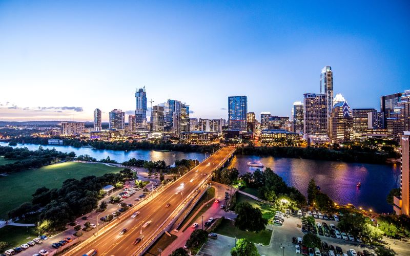 A shot of the Austin, Texas, skyline and the Colorado River at twilight