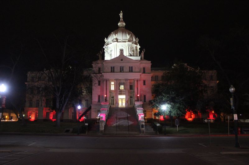 A shot of the façade of the Mclennan County Courthouse in Waco, Texas, at night