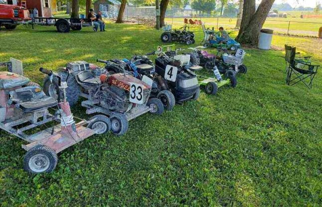 Lawn mowers lined up for a lawn mower race