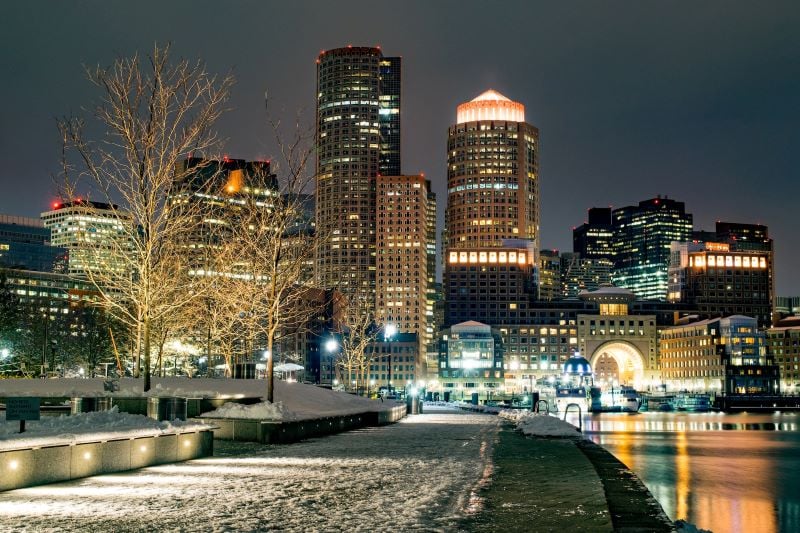 Lights glow from high-rise buildings on a wintery night in Boston.