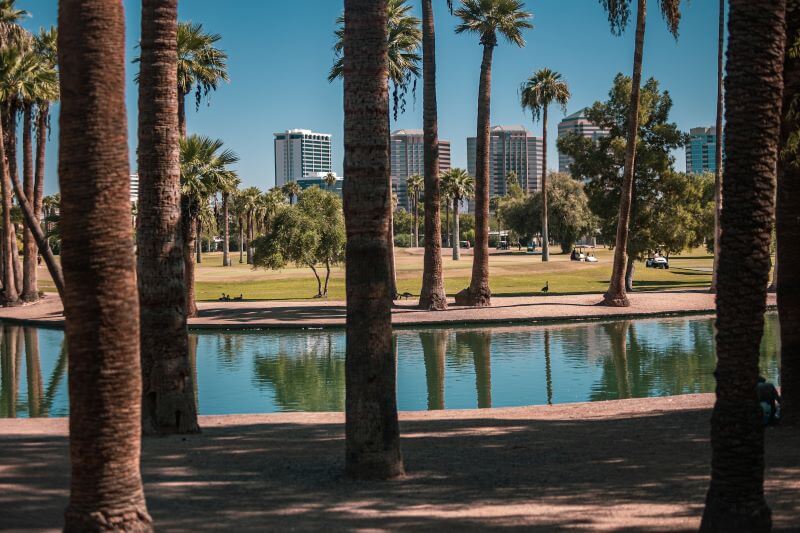 A view of buildings in Phoenix shot from the Encanto Park lagoon