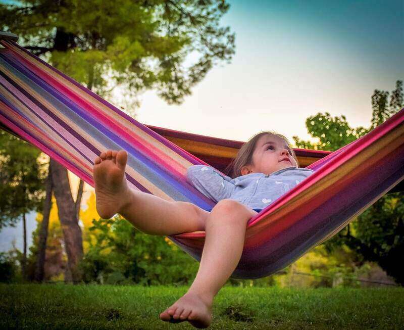 kid sitting on a hammock