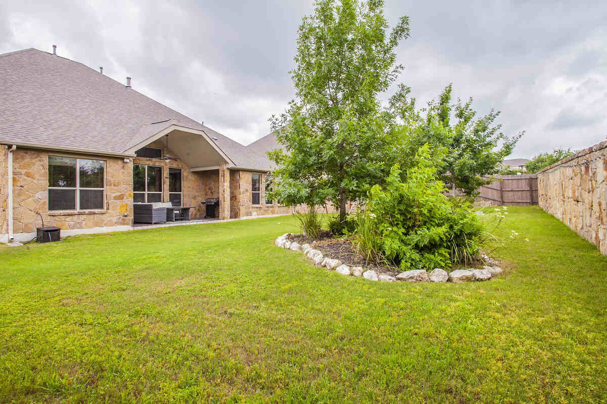 image of a green grass in front of a house