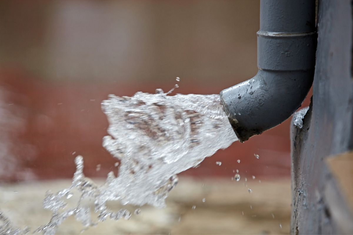 Text: Direct Water from Gutter | Background Image: Water comming from gutter pipe