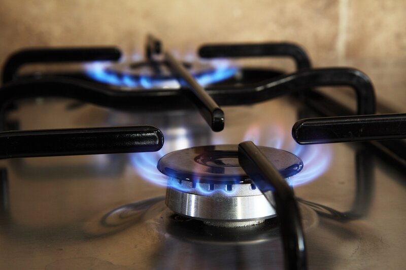 Text: Kitchen stove | Background Image: Fire is comming from the kitchen stove and the natural gas is burning