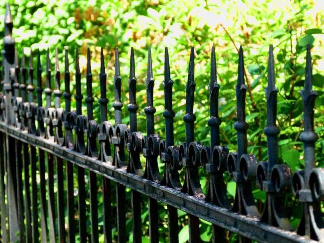 A metal fence of a lawn of a house