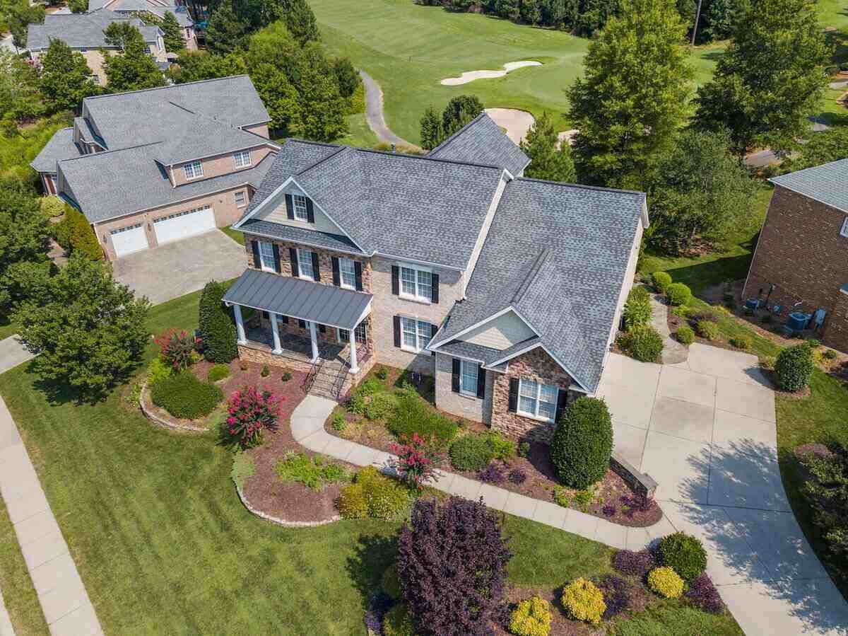 Top Roof of a home with green lawn with grass, tree and yard