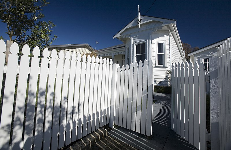 A white house with a wooden fence