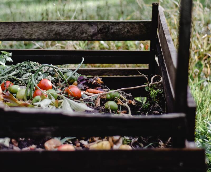 A compost pile containing vegetables and leaves