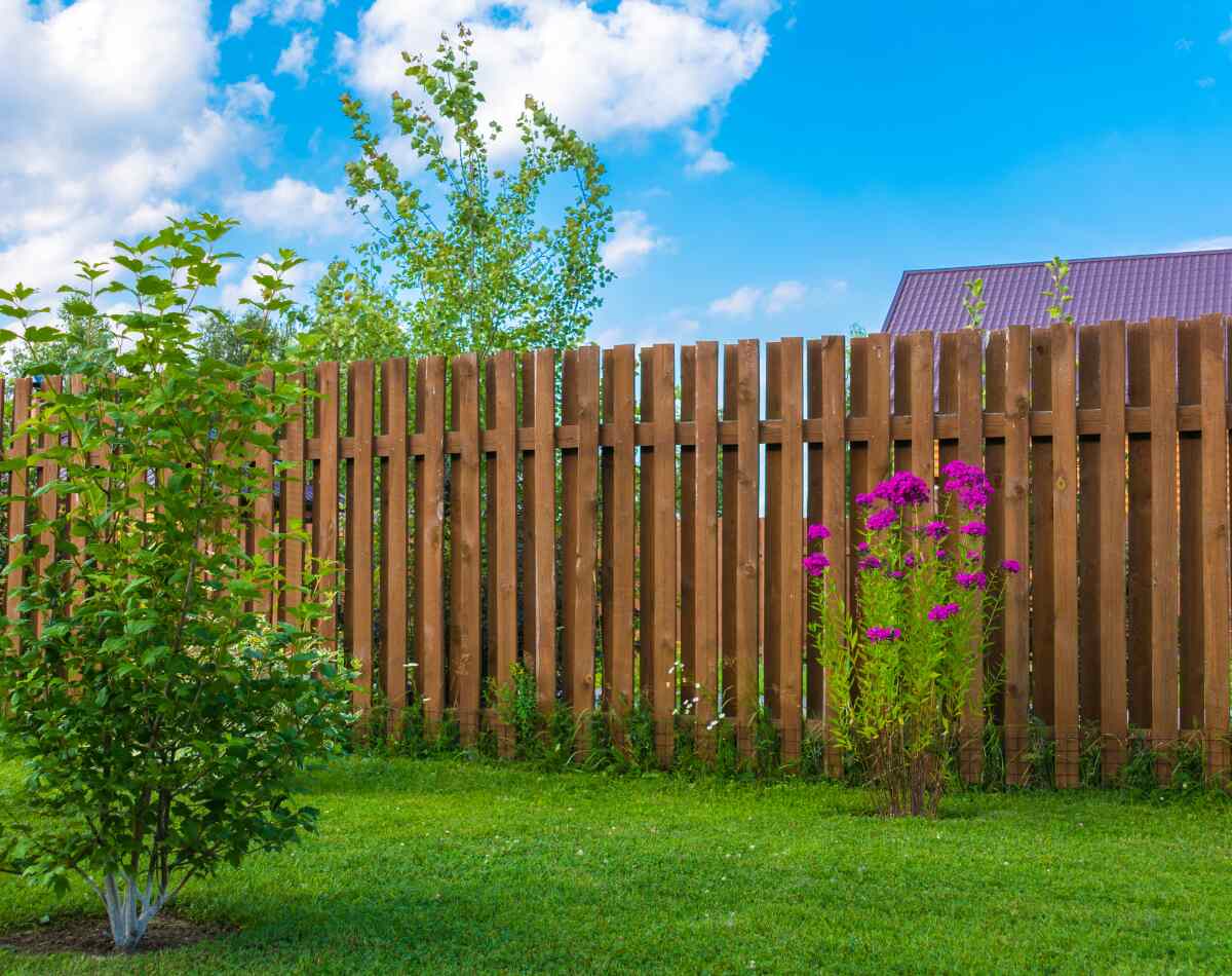 A beautiful wooden fence of a lawn