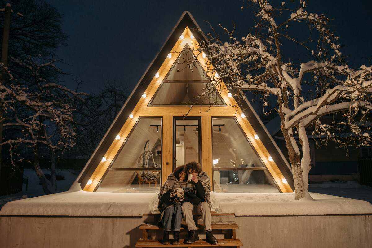 couple sitting in front of a house