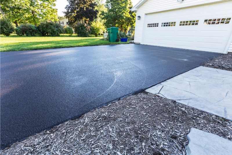 Asphalt driveway with a garage door