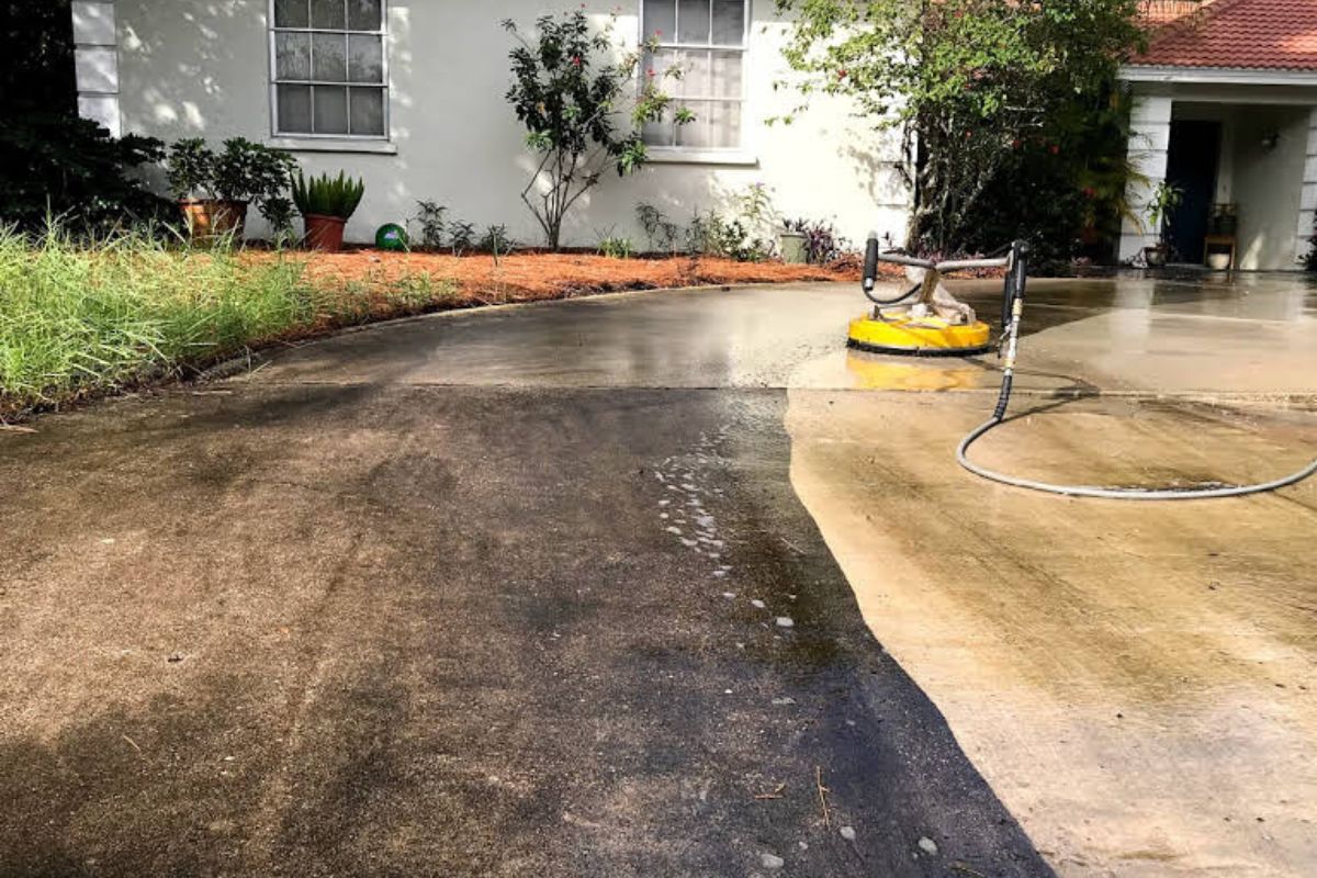 Pressure washer on half cleaning driveway