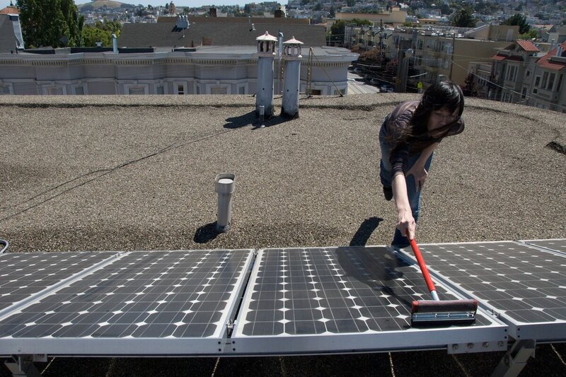 Girl Cleaning the Home Solar Panel
