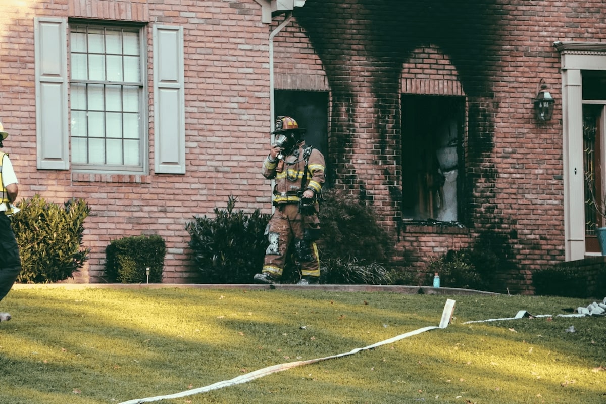 Fire Man Coming out from burned house