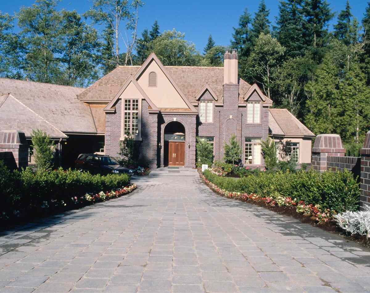 picture of a driveway going towards a house