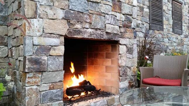 A house of stones with a wood fireplace built of the same stone