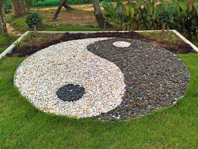Yin and Yang illustration made with rocks in a garden