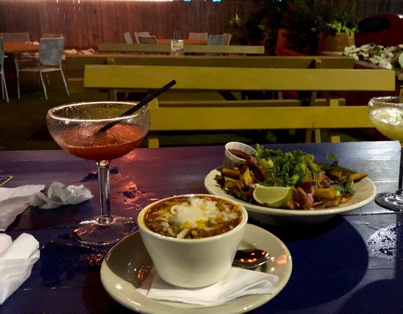 f chili alongside a plate of salad and a margarita on a table in Bombay Bicycle Club’s outdoor patio. 
