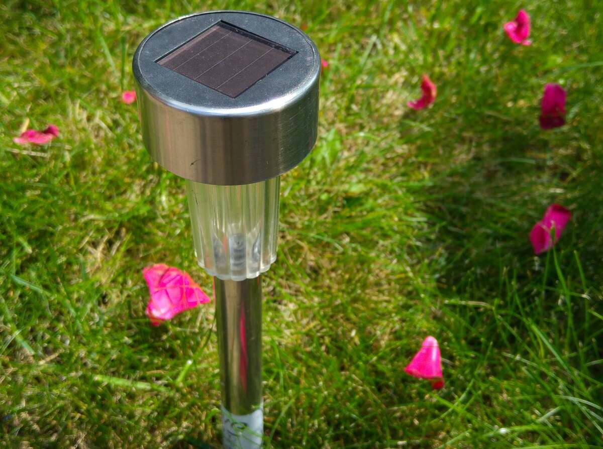 A solar landscape light installed in a garden of house