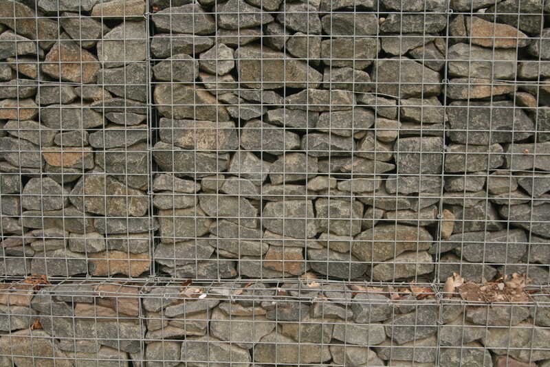 A gabion basket holding large number of rocks