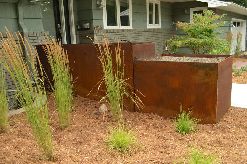 A corten steel retaining wall in a yard