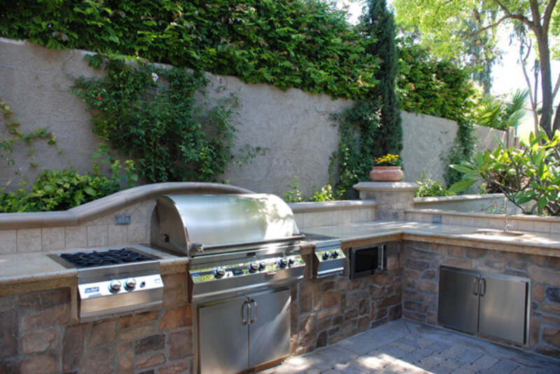 A picture showing a outdoor kitchen of a house